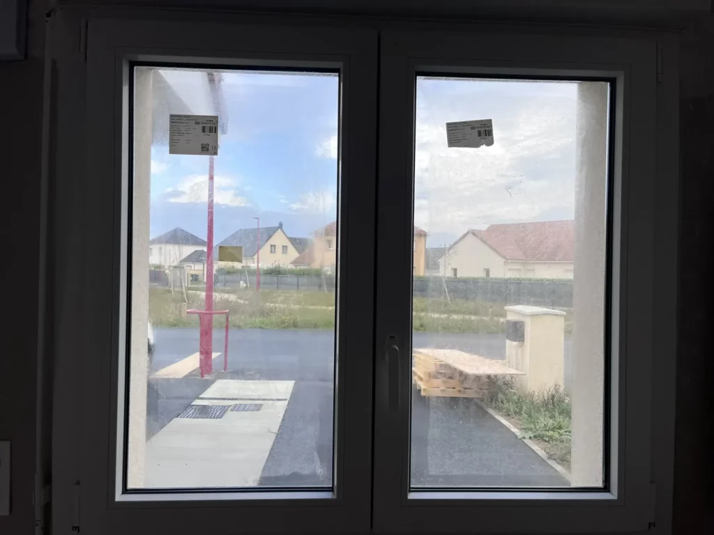 Fenêtres neuves avant nettoyage de fin de chantier, vitrages salis
